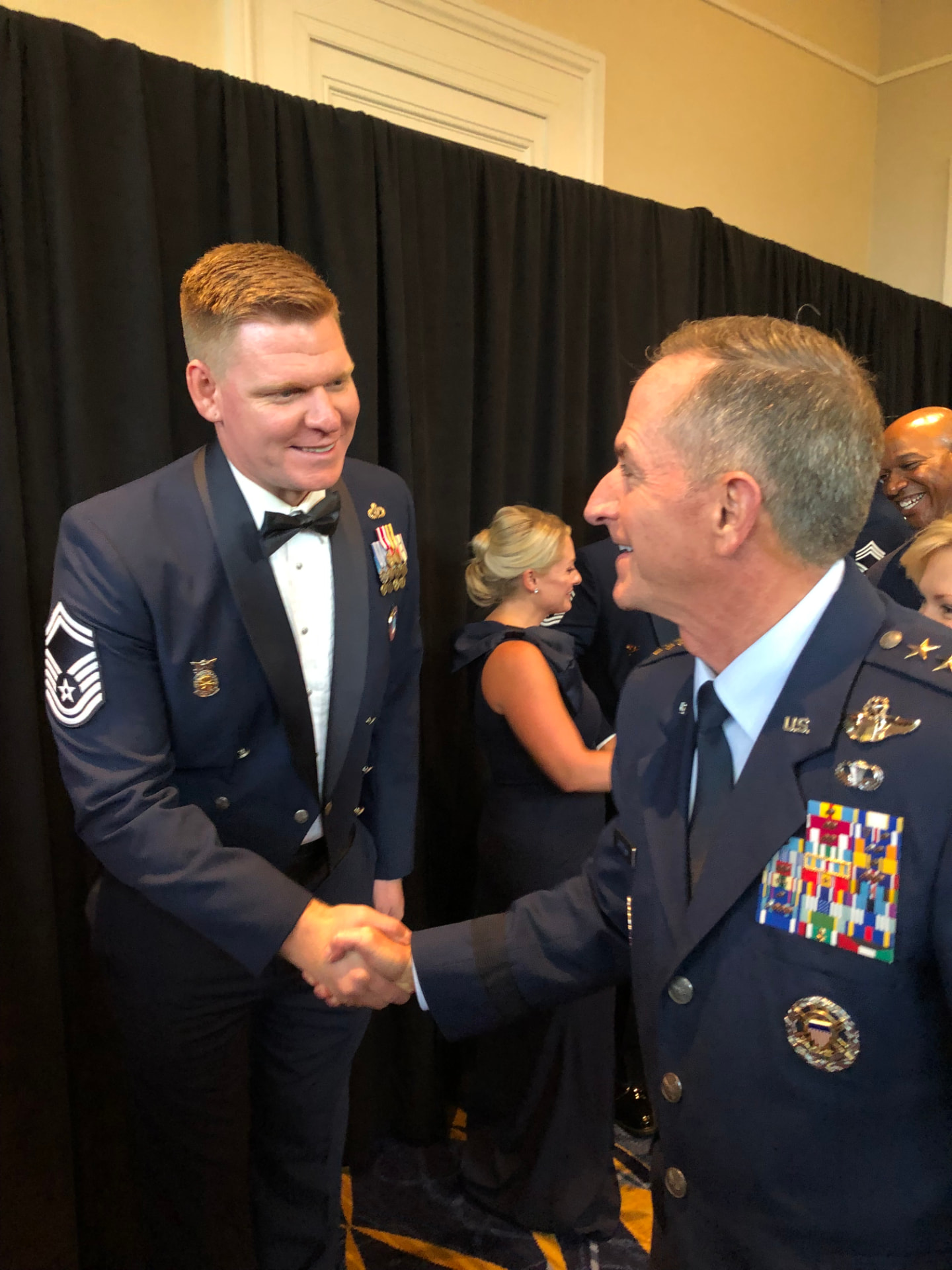 AJ Kehl shaking hands with an Air Force general at a formal event