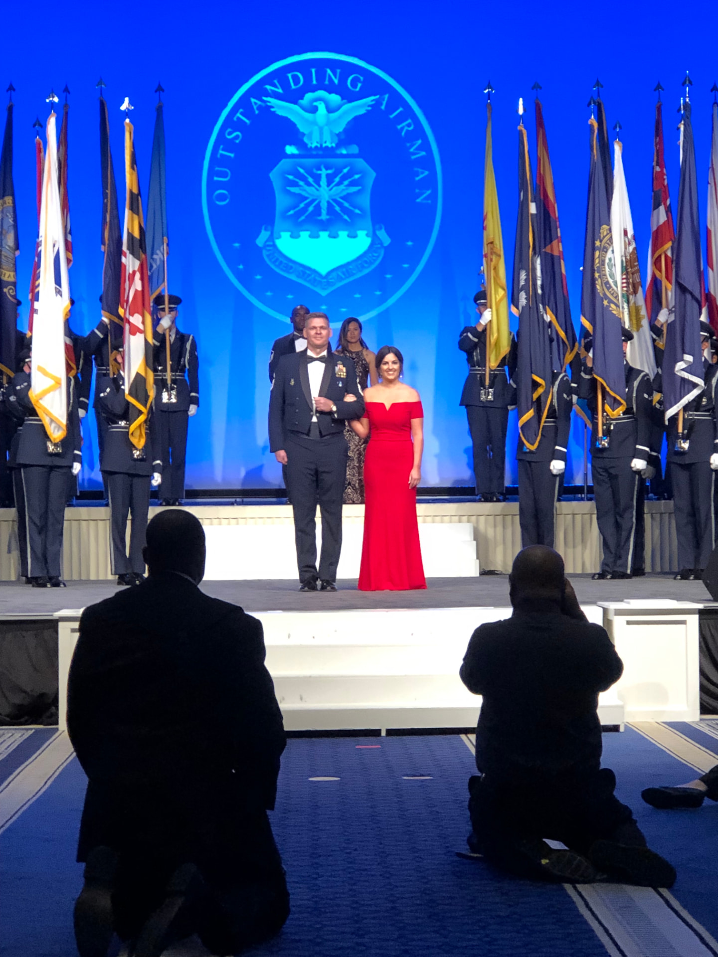 AJ Kehl and his wife on stage at the Outstanding Airmen of the Year ceremony